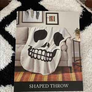 Cupcakes & Cashmere Black and White skull Shaped Throw